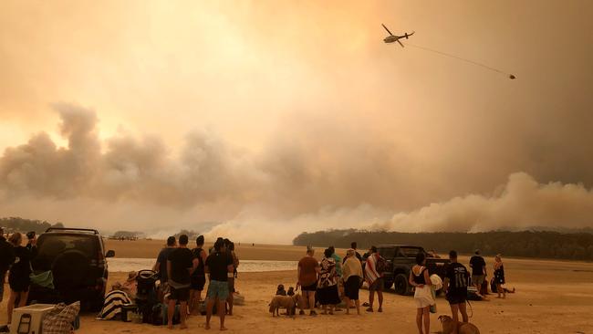 Residents watch waterbombing of raging fires on New Year’s Eve at Lake Conjola in New South Wales. Picture: Supplied