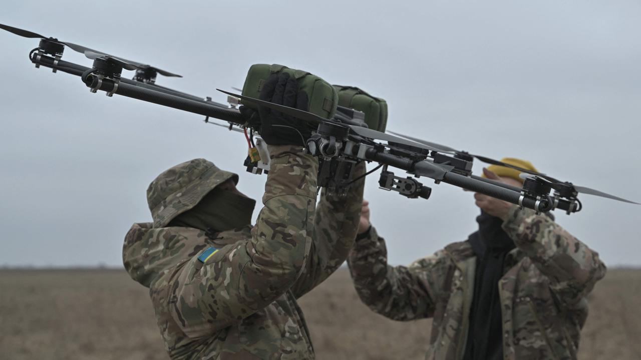 Pilots carry a drone on a training ground in Kyiv regionlast month, amid the Russian invasion of Ukraine. A wave of drone strikes have targeted Russia’s oil refineries and border regions. Picture: Genya Savilov/AFP