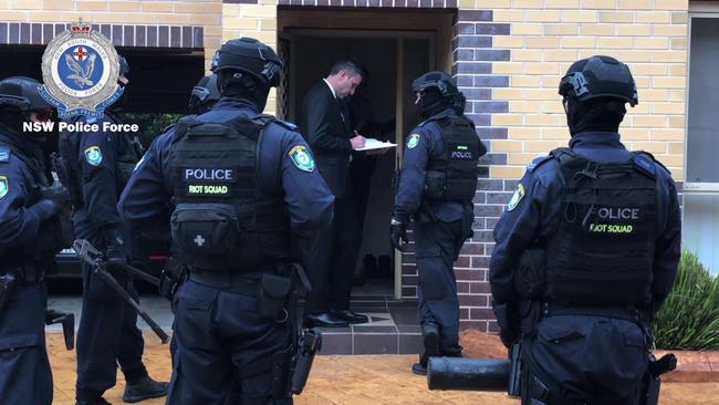 Police during a raid at a Cambridge Park home in November 2018.