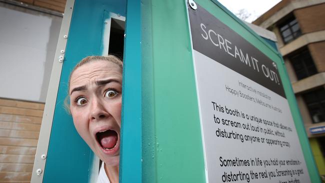 Victoria University students use a “scream booth” at the Footscray campus's 'De-Stress Fest' to reduce stress prior to final exams and assignments. . Picture: David Caird