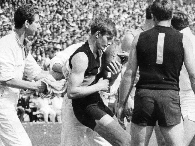 Royce Hart is dazed and concussed after having been sandwiched between two Sturt players in the first quarter.