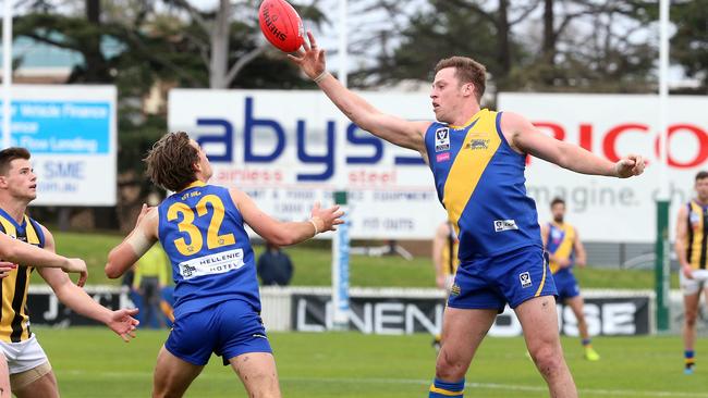 Nick Meese taps the ball to a grateful Williamstown teammate.