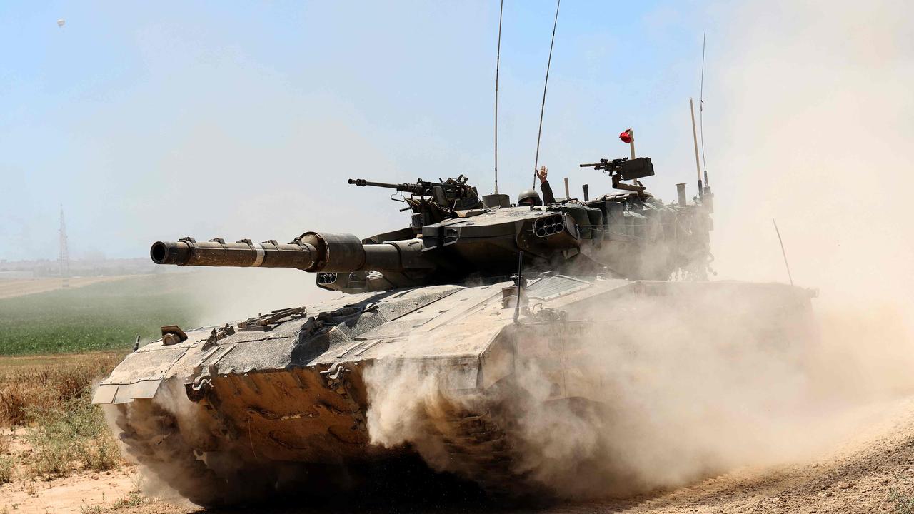 An Israeli army battle tank moves near the border with the Gaza Strip at a location in southern Israel on May 15, 2024, amid the ongoing conflict in the Palestinian territory between Israel and the Hamas movement. (Photo by JACK GUEZ / AFP)