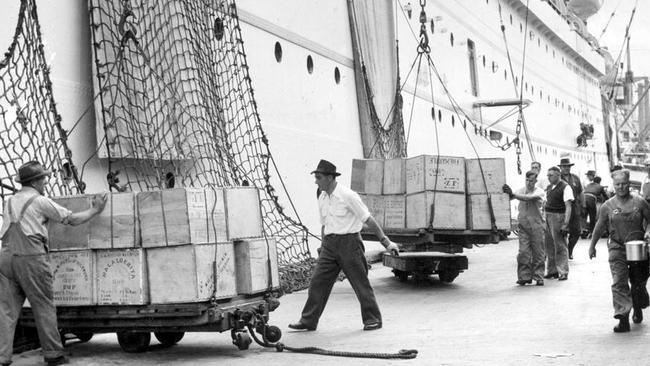 Ships being unloaded at Melbourne docklands in 1956, shortly before the docks were moved further down the Yarra River. Picture: HWT Library