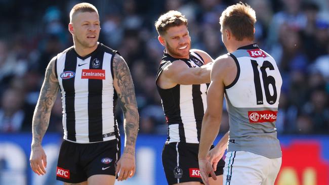 Taylor Adams (middle) confronts Port Adelaide midfielder Ollie Wines in Saturday’s win over the Power. Picture: Getty Images