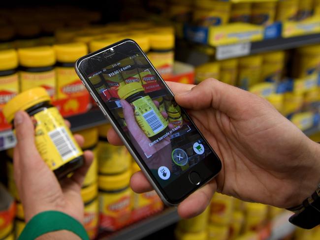 Woolworths employee Bryn Rayfield uses the new Scan &amp; Go app at the Double Bay store in Sydney. Picture: Dan Himbrechts