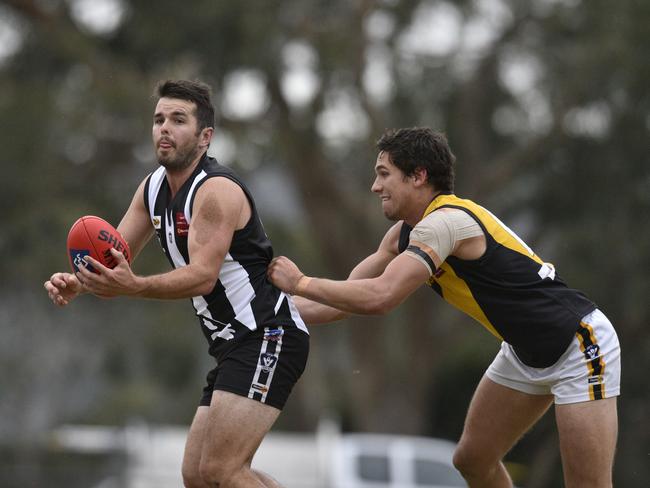 James Brown fires off a handball for Belgrave. Picture: Christopher Chan.