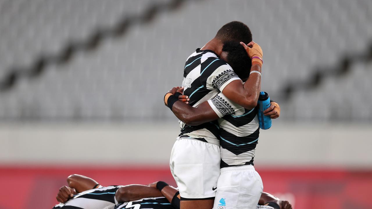 Jerry Tuwai and Meli Derenalagi embrace following their gold medal triumph over New Zealand. Photo: Getty Images