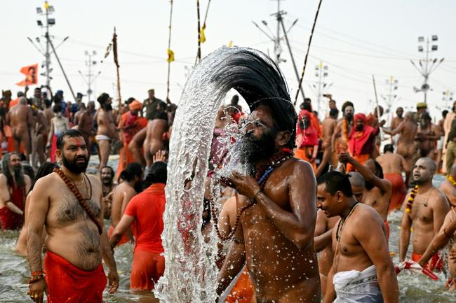 Swarming throngs of devotees bathed in rivers at the world's biggest religious gathering in India on Thursday