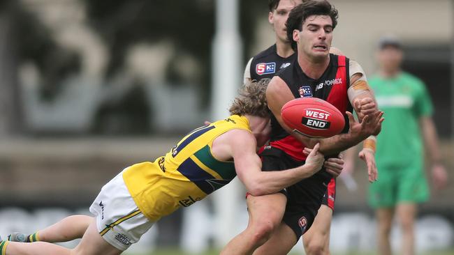 West Adelaide’s Owen Mulady is caught in a flying tackle by Woodville-West Torrens’ Max Beattie at Richmond Oval. Picture: Dean Martin.