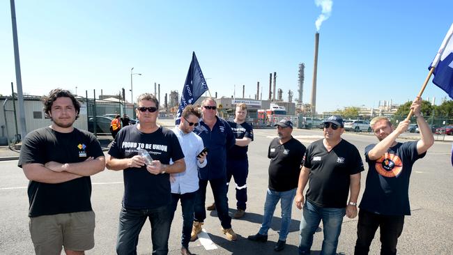 Workers outside the Exxon Mobil refinery at Altona after the company announced it would close the facility. Picture: Andrew Henshaw