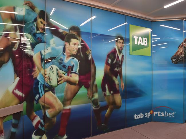 A TAB betting shop is seen in a shopping arcade in Sydney on April 19, 2017. Australian gaming and lottery giant Tatts said it had received a revised multi-billion-dollar takeover offer from a consortium led by US private equity firm KKR, challenging a planned merger with rival Tabcorp. / AFP PHOTO / PETER PARKS