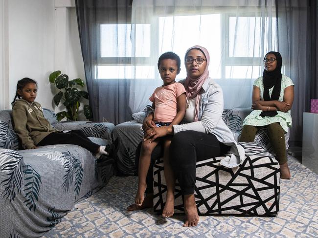 Hadia Komba with her children, from left, Rayan, 6, Zakir, 4, and Nadine, 12, in their Flemington housing commission apartment in Melbourne. Picture: Aaron Francis