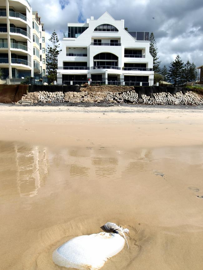 Land will be lost from some of the Gold Coast’s most prestigious beachfront properties in the next super storm because the protective rock wall is buried inside their property boundaries.