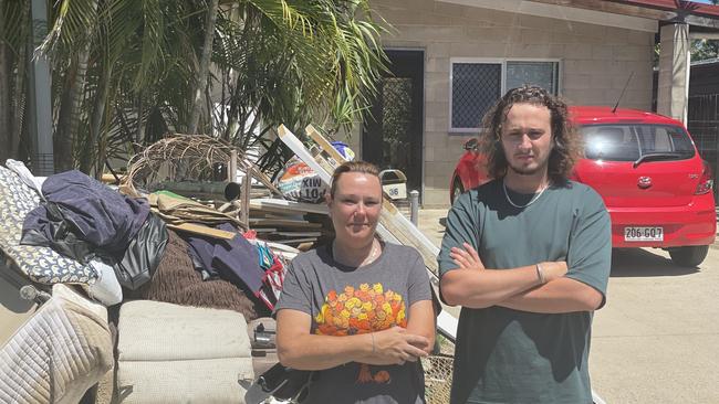 Katie Britt and her stepson Jacob Pearson stand in front of her Halloways Beach home which was flooded during Cyclone Jasper's deluge. Photo: Dylan Nicholson