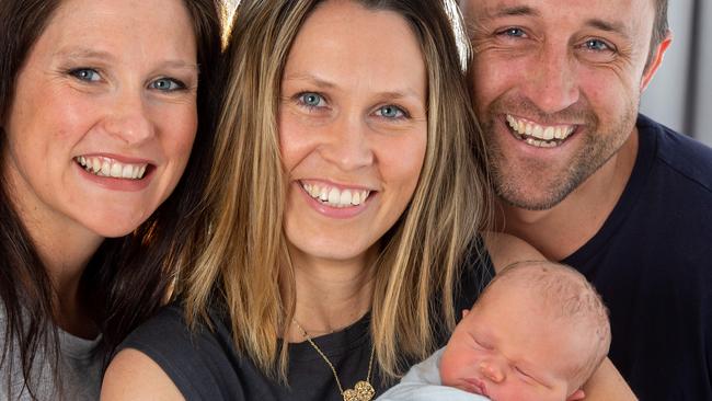 Fiona Davey gave birth to her younger sister Penny Hansen's baby – a boy, William Davey Hansen. Fiona (left) with Penny holding William and Penny's husband, Leigh. Picture: Jay Town