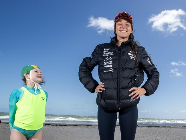 Ironwoman Lucy Derbyshire with Glenelg nippers Willow Deeble and Ollie Findlay, both 8 at Glenelg Beach, 21 October 2023. Picture Simon Cross