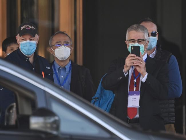 Dominic Dwyer (R) and other members of the World Health Organization (WHO) team investigating the origins of the Covid-19 pandemic, leave the Hilton Wuhan Optics Valley Hotel where the team is currently based post-quarantine in Wuhan, Chinaâs central Hubei province on January 29, 2021. (Photo by Hector RETAMAL / AFP)