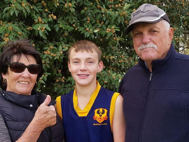 Fatal tribute - Roger Bates . Roger, Judith and grandson Jakob at SAPSASA football . Picture: Supplied by family