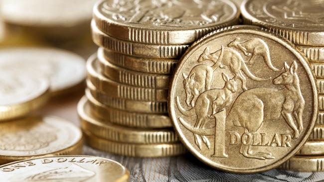 Stacks of Australian one dollar coins. Focus on front coin.