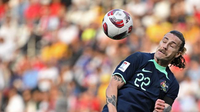 Australia's midfielder #22 Jackson Irvine heads the ball during the Qatar 2023 AFC Asian Cup Group B football match between Syria and Australia at the Jassim bin Hamad Stadium in Doha on January 18, 2024. (Photo by HECTOR RETAMAL / AFP)