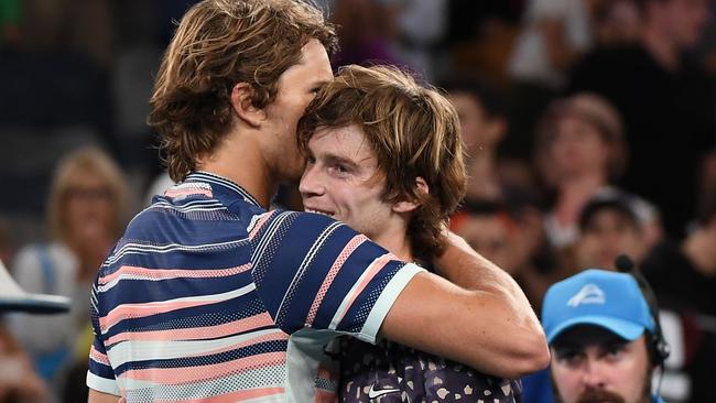 Zverev gets a hug from his friend, Andrey Rublev, after their fourth round match.