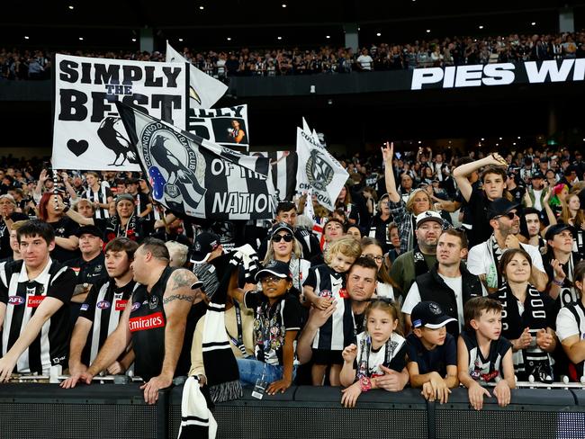 MELBOURNE, AUSTRALIA - APRIL 25: Collingwood fans celebrate during the 2023 AFL Round 06 match between the Collingwood Magpies and the Essendon Bombers at the Melbourne Cricket Ground on April 25, 2023 in Melbourne, Australia. (Photo by Dylan Burns/AFL Photos via Getty Images)