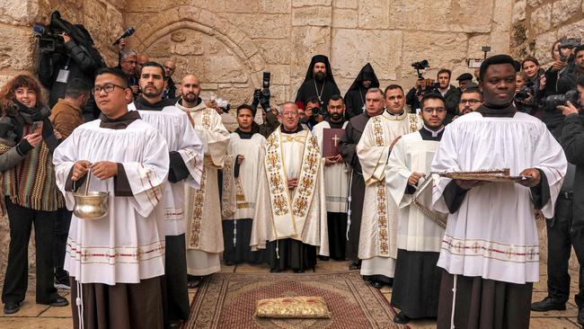 Latin, Greek, and Armenian Catholic clergymen await the arrival of the Latin Patriarch of Jerusalem for Christmas Eve celebrations in Bethlehem. Picture: Hazem Bader/AFP