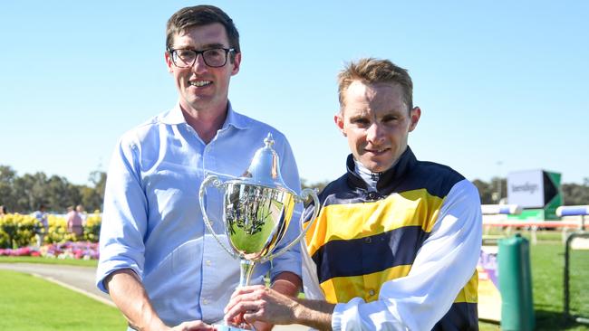 Harry Eustace holding the Bendigo Cup trophy with Declan Bates. Eustace has enjoyed significant success in Australia for English trainer William Haggas. Picture: Brett Holburt/Racing Photos via Getty Images