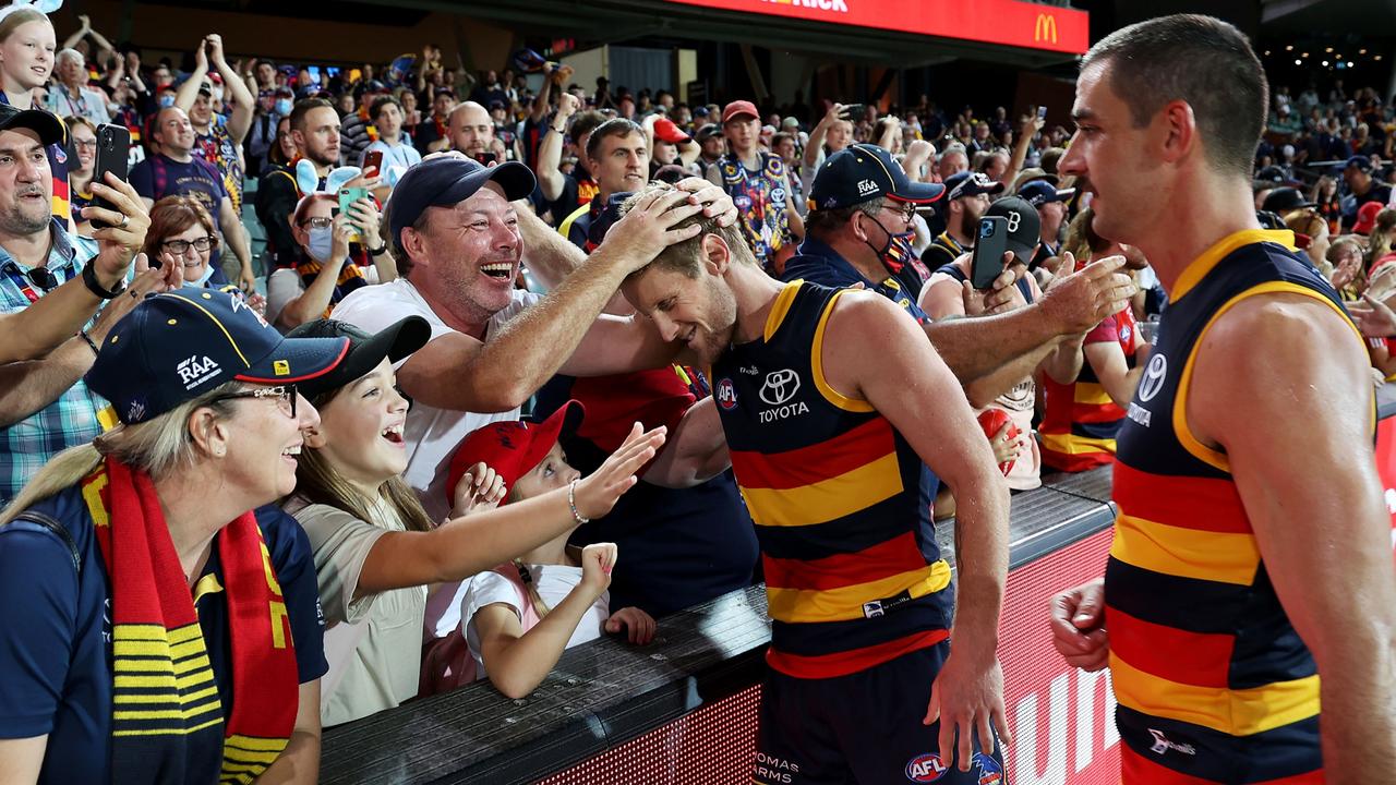 Rory Sloane and Taylor Walker celebrate a win with Crows fans.