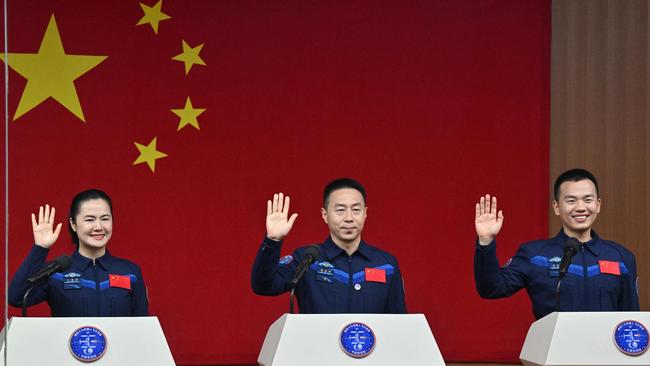 (L-R) Astronauts Wang Haoze, Cai Xuzhe and Song Lingdong salute during a press conference a day before the launch. Picture: AFP.