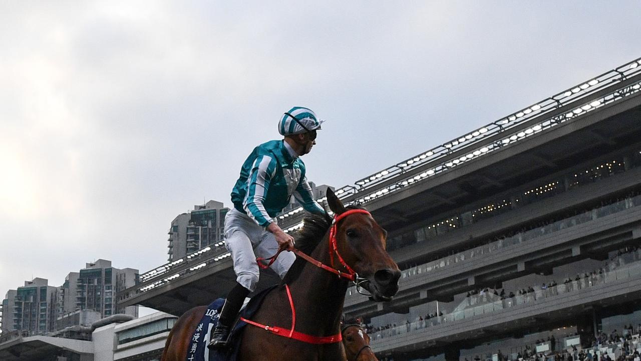 HONG KONG, CHINA - DECEMBER 08: James McDonald riding Romantic Warrior winning Race 8, the Longines Hong Kong Cup during racing at Sha Tin Racecourse on December 08, 2024 in Hong Kong, China. (Photo by Vince Caligiuri/Getty Images)