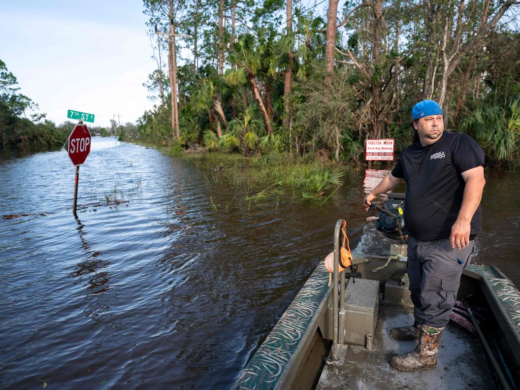 PJ Brashear operates a duck boat that he's been using to retrieve people stranded in flooded neighbourhoods in Florida. Picture: AFP.