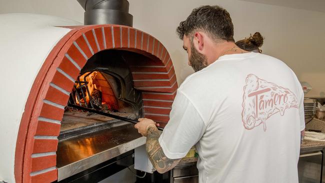 Marc Kinvig works the wood-fired oven at T’amerò. Picture: Jerad Williams