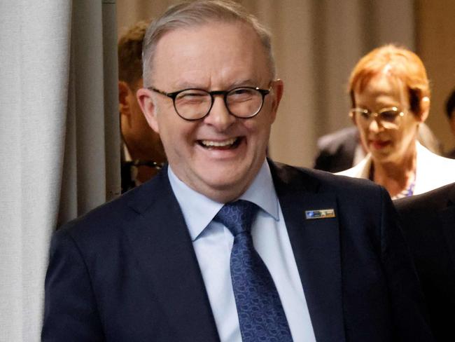 Australian Prime Minister Anthony Albanese (L) smiles next to French President Emmanuel Macron on the sidelines of the NATO summit, in Vilnius on July 11, 2023. NATO leaders will grapple with Ukraine's membership ambitions at their summit on July 11, 2023, their determination to face down Russia boosted by a breakthrough in Sweden's bid to join the alliance. (Photo by Ludovic MARIN / AFP)