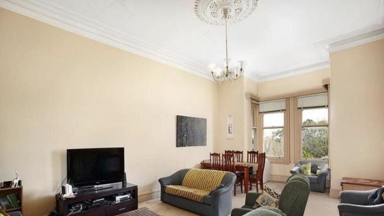 Parts of the home’s original timber flooring and detailed plasterwork were still visible before the restoration began.