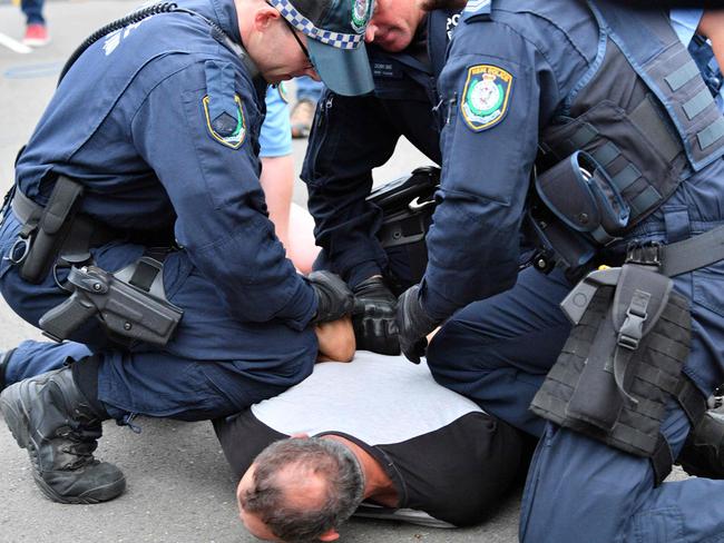 Police detain a protester before right-wing British provocateur Milo Yiannopoulos arrived.