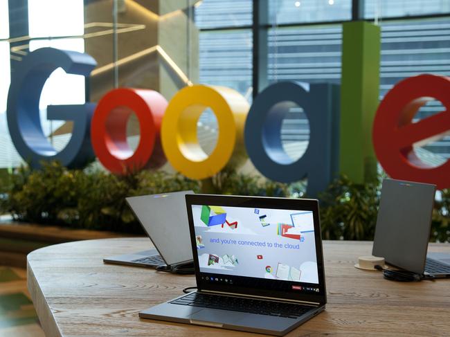 Google Inc. Chromebook laptop computers sit on display in front of a sign featuring the company's logo at the company's Asia-Pacific headquarters during its opening day in Singapore, on Thursday, Nov. 10, 2016. Google officially opened its new hub in Singapore today. Photographer: Ore Huiying/Bloomberg