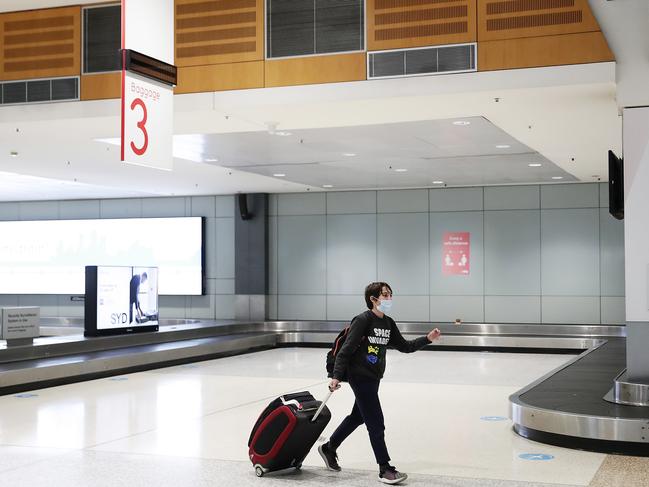 SYDNEY, AUSTRALIA - JULY 08: A passenger, off a Melbourne to Sydney flight, arrives at Sydney domestic airport on July 08, 2020 in Sydney, Australia. The NSW-Victoria border closed at midnight, Wednesday 8 July. It is the first time in 100 years the border between the two states has been closed and comes as Victoria continues to record high numbers of confirmed COVID-19 cases through community transmission. NSW residents returning from Victoria will need to self isolate for 14 days, while Victorian residents are banned from travelling to New South Wales unless they have a permit. Special provisions will be in place for border communities such as Albury-Wodonga as well as freight operations and other critical services. (Photo by Mark Metcalfe/Getty Images)