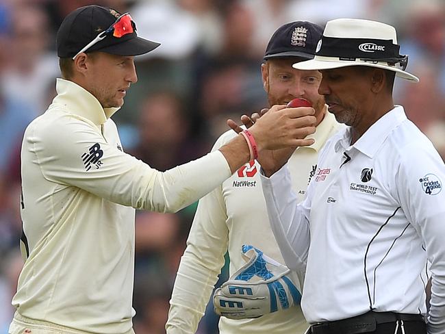 BIRMINGHAM, ENGLAND - AUGUST 04: England captain Joe Root holds up the ball for umpire Joel Wilson to smell during day four of the 1st Specsavers Ashes Test between England and Australia at Edgbaston on August 04, 2019 in Birmingham, England. (Photo by Gareth Copley/Getty Images)