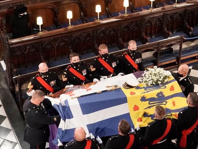 Queen Elizabeth II watches as pallbearers carry the coffin of her husband, Prince Philip, Duke of Edinburgh during his funeral inside St George's Chapel. Picture: Jonathan Brady/POOL/AFP