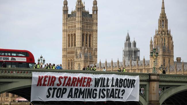 A banner reading ‘Keir Starmer: Will Labour Stop Arming Israel?‘ is hung over the side of Westminster Bridge in London in June. Picture: AFP