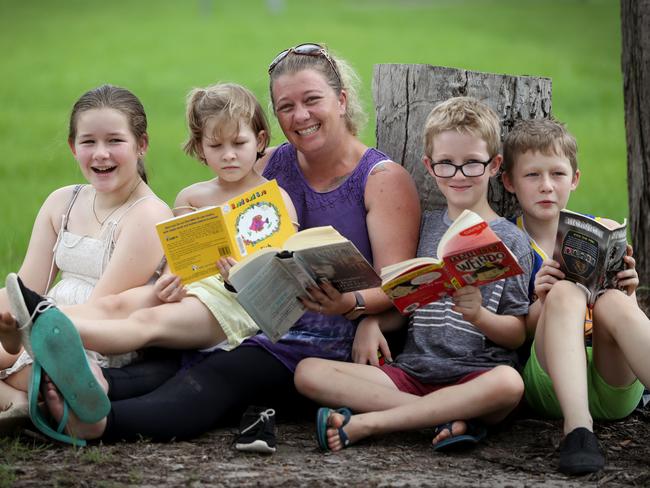 Cyndi Baker reading with her children Nathen, 11, Louieze, 8, Kacy, 13 and Kamb, 10. Picture: Jamie Hanson