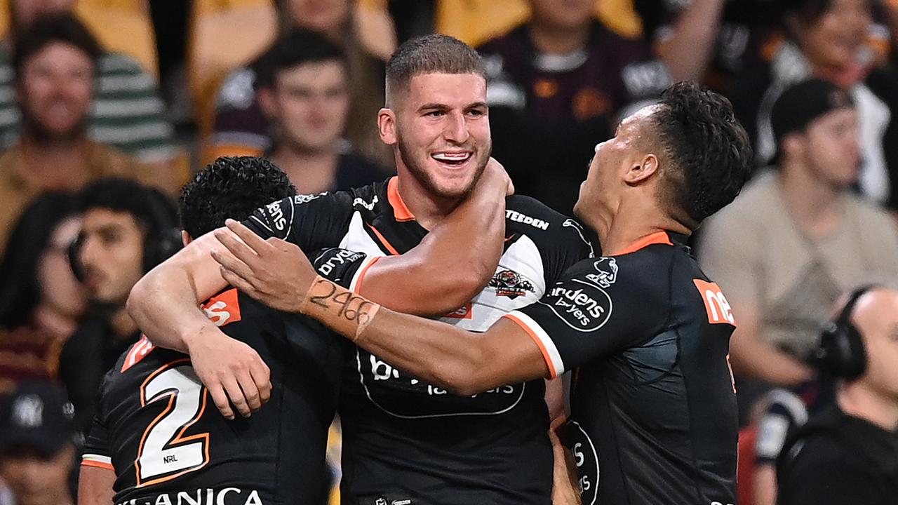 BRISBANE, AUSTRALIA - MAY 14: Adam Doueihi of the Tigers celebrates with teammates after scoring a try during the round 10 NRL match between the Wests Tigers and the Newcastle Knights at Suncorp Stadium on May 14, 2021, in Brisbane, Australia. (Photo by Bradley Kanaris/Getty Images)