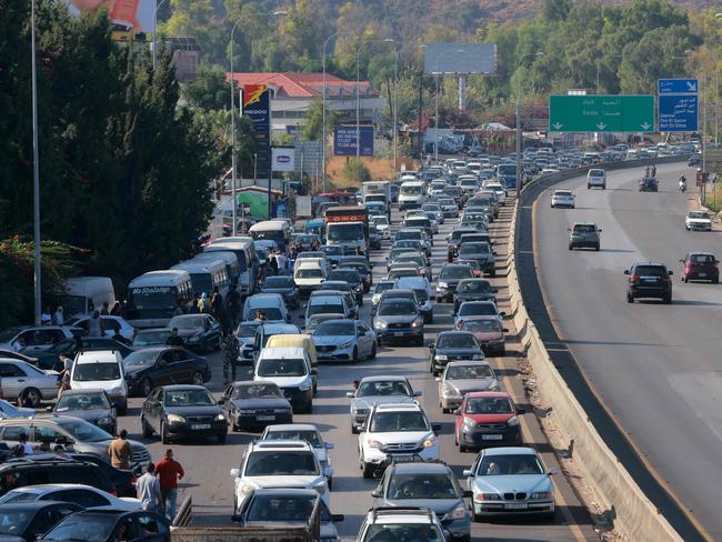 Vehicles wait in traffic in the town of Damour, south of the capital Beirut as people flee southern Lebanon. Picture: AFP.