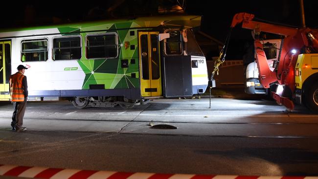 A tram is put back on to the tracks after it smashed into a fire hydrant and derailed in Ascot Vale. Picture: Nicole Garmston