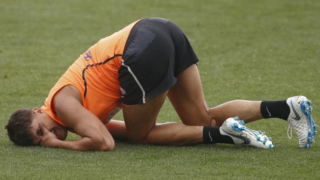 Jarrod Pickett holds his knee after a collision at Carlton training.