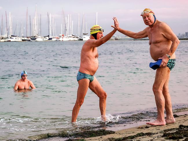 Peter Madison gives Garry Johnson a high five as he emerges from the water. Picture: Ian Currie