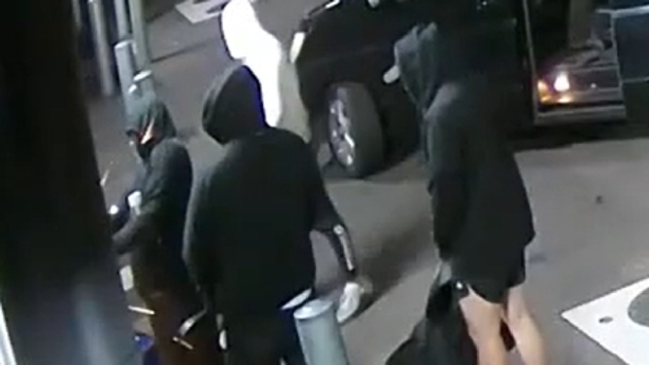 Watch: Masked group caught on CCTV breaking into business