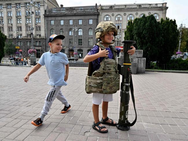 The boy posed for photos at a volunteers point in the centre of Kyiv. Picture: AFP